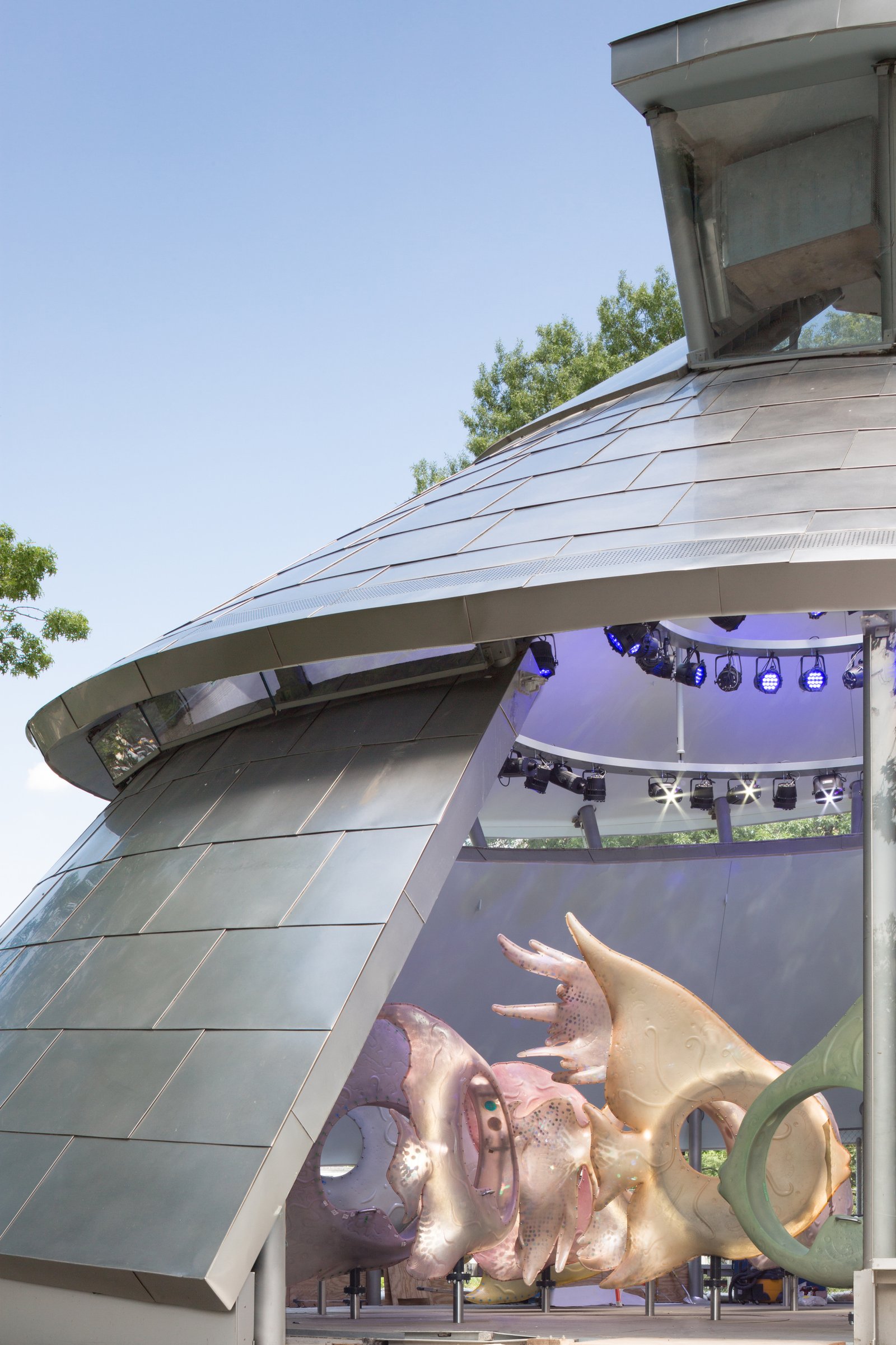 Close-up of the SeaGlass Carousel structure with large fish sculptures inside.