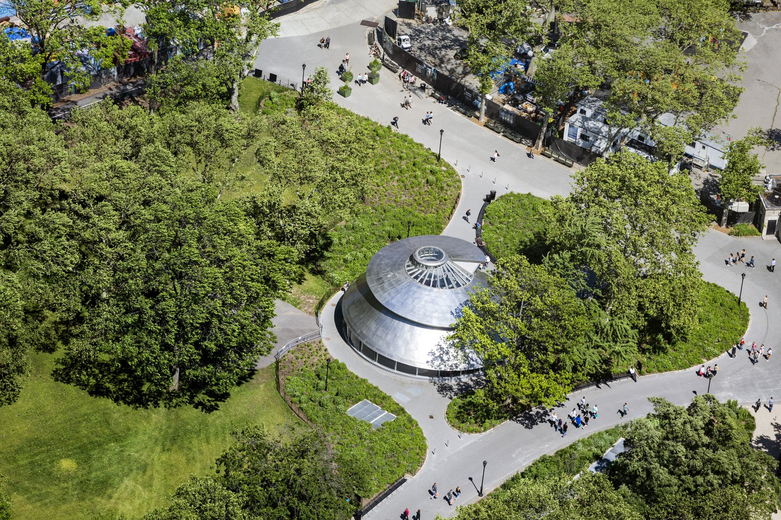 Aerial view of SeaGlass Carousel surrounded by greenery in Battery Park.