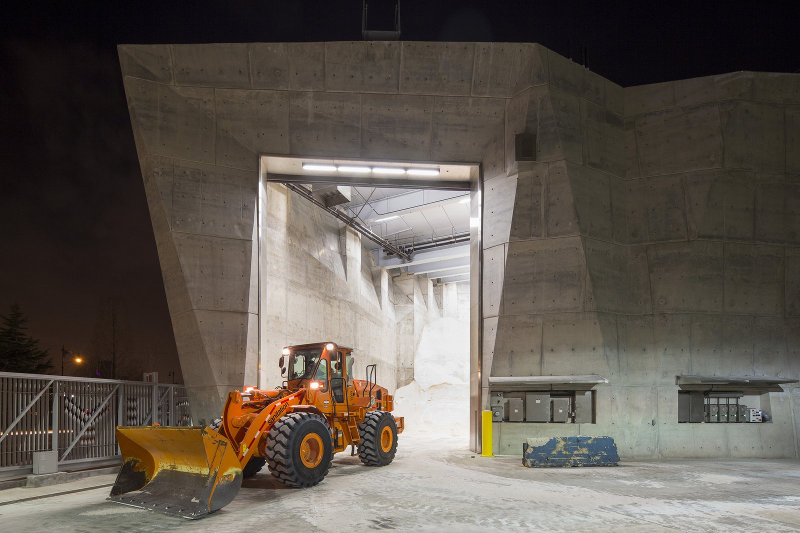 Loader inside the Salt Shed, with a view of stored salt and concrete walls.