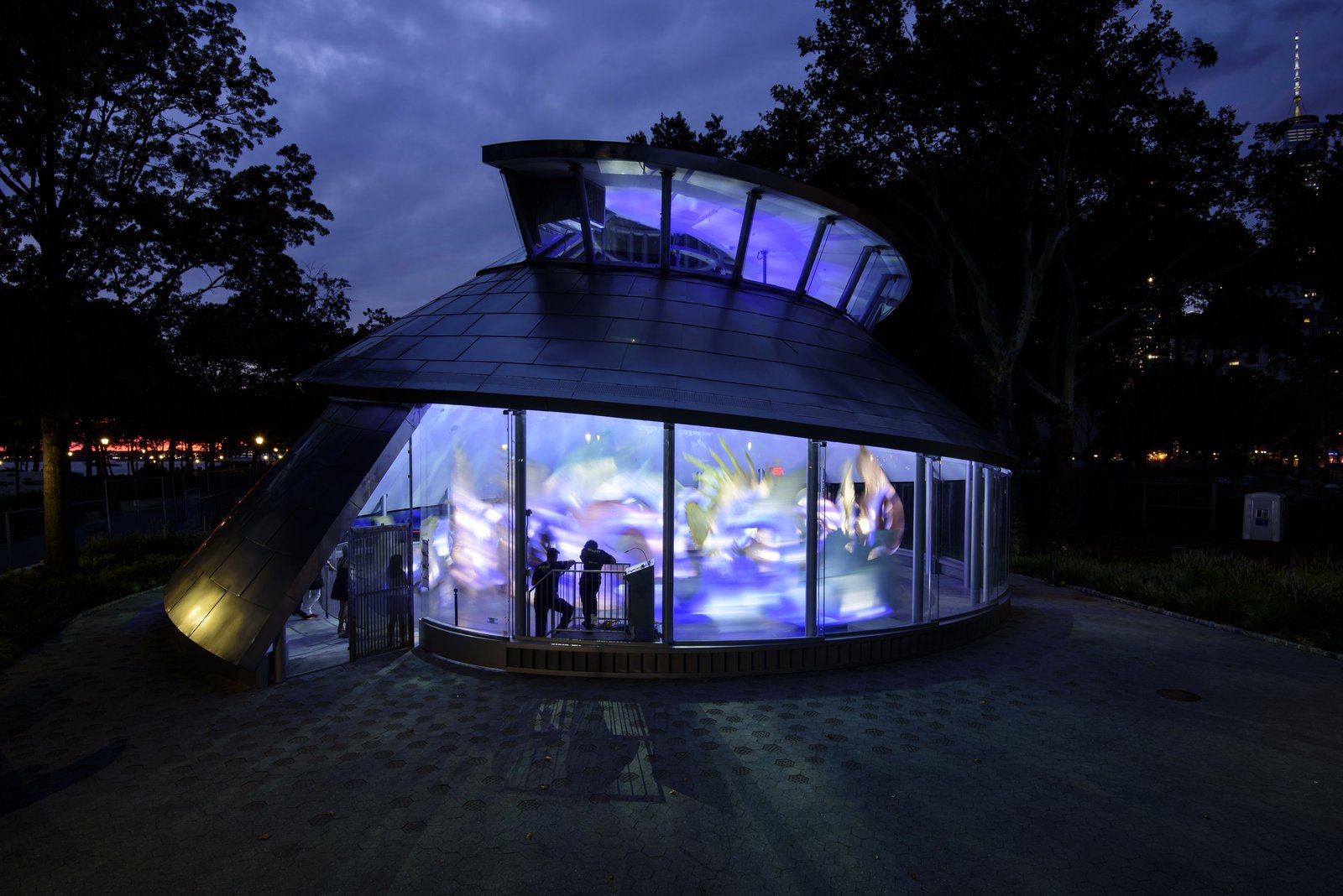 SeaGlass Carousel illuminated with vibrant colors at night in Battery Park.