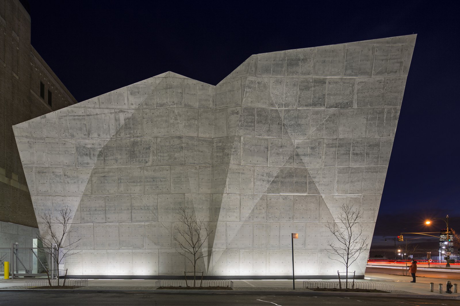 Night view of the sculptural concrete Salt Shed at Spring Street.