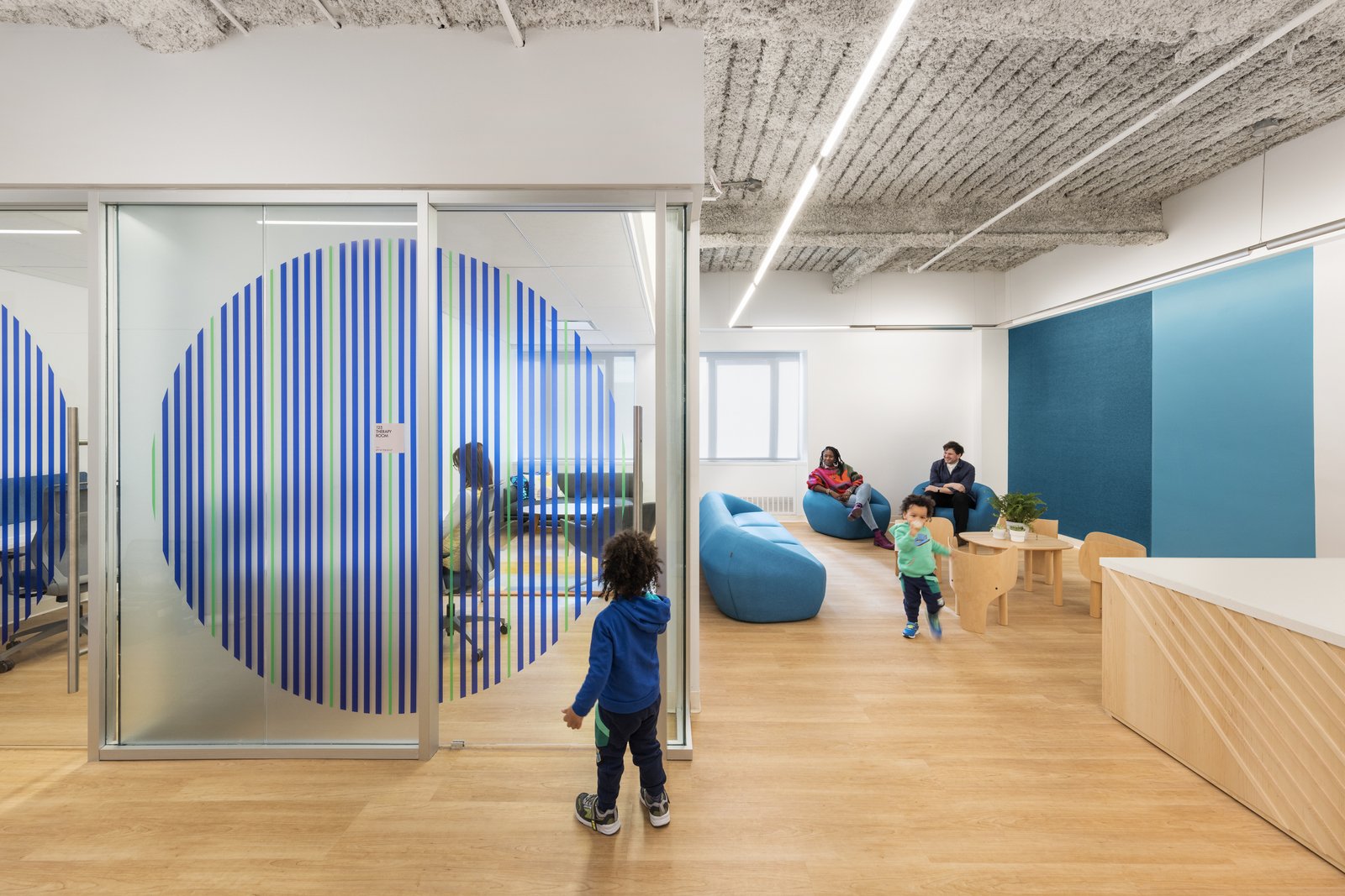 Child-friendly play area with blue accents and comfortable seating.