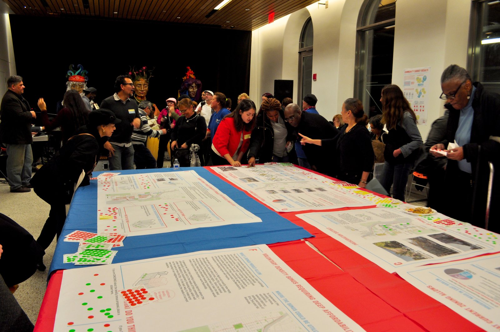 Community members gathered around planning boards at a workshop.