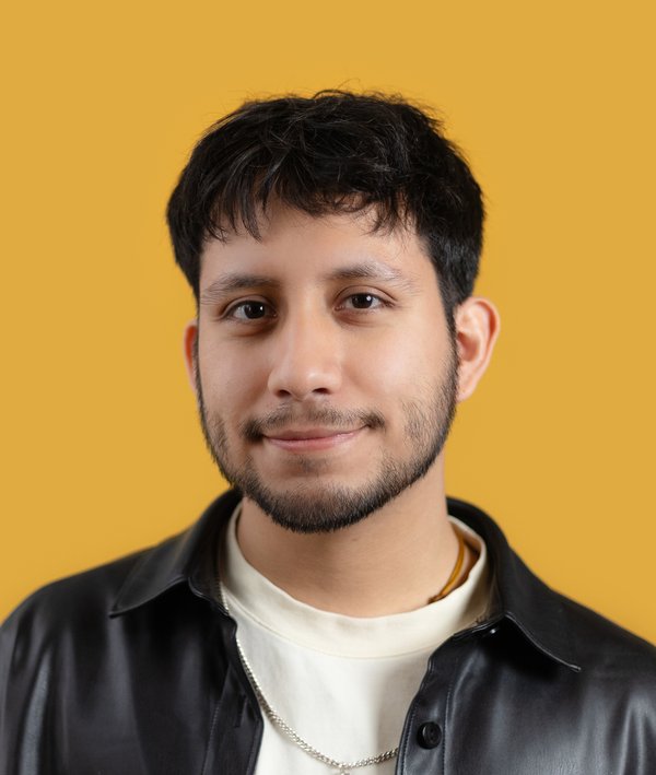 Headshot of Alexis Luna against a yellow background.