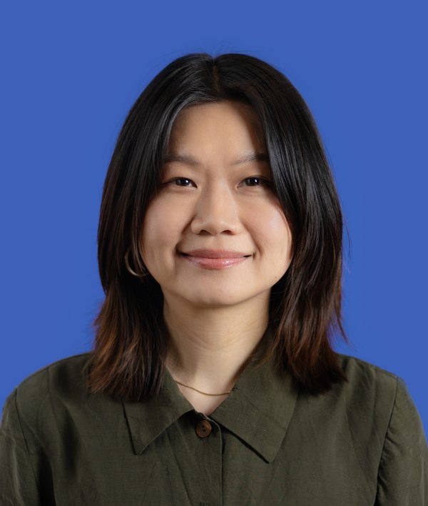 Headshot of Alice Song in a green top against a blue background.