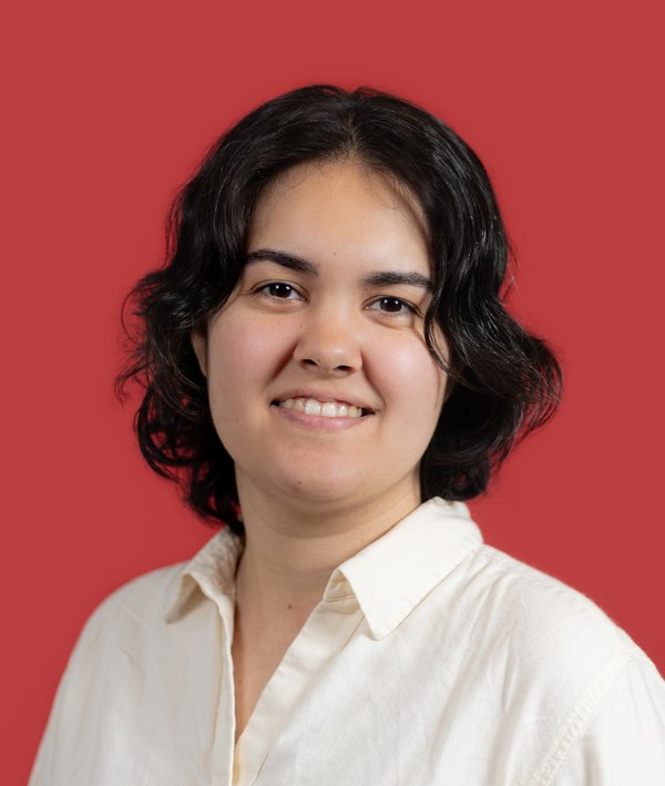 Headshot of Helen Fialkowski in a white top against a red background.