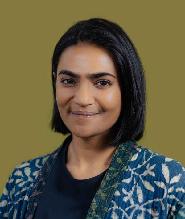 Headshot of Radhika Singh against a green background.