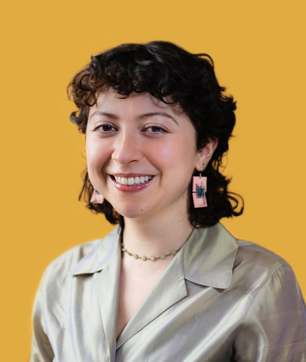 Headshot of Nathalie Kauz against a yellow background.