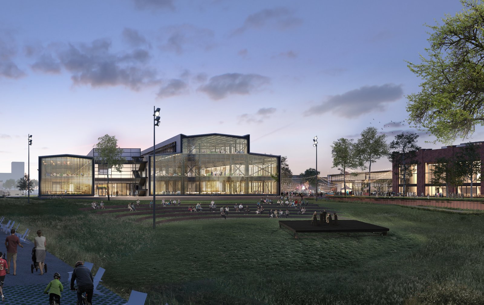 A rendering of illuminated glass and steel building with tiered lawn amphitheater and walking paths.