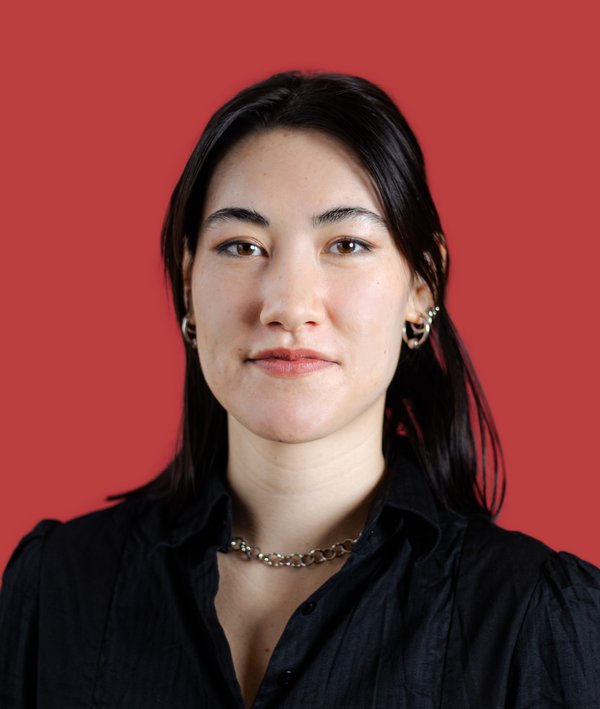 Headshot of Olivia Jia in a black top against a red background.