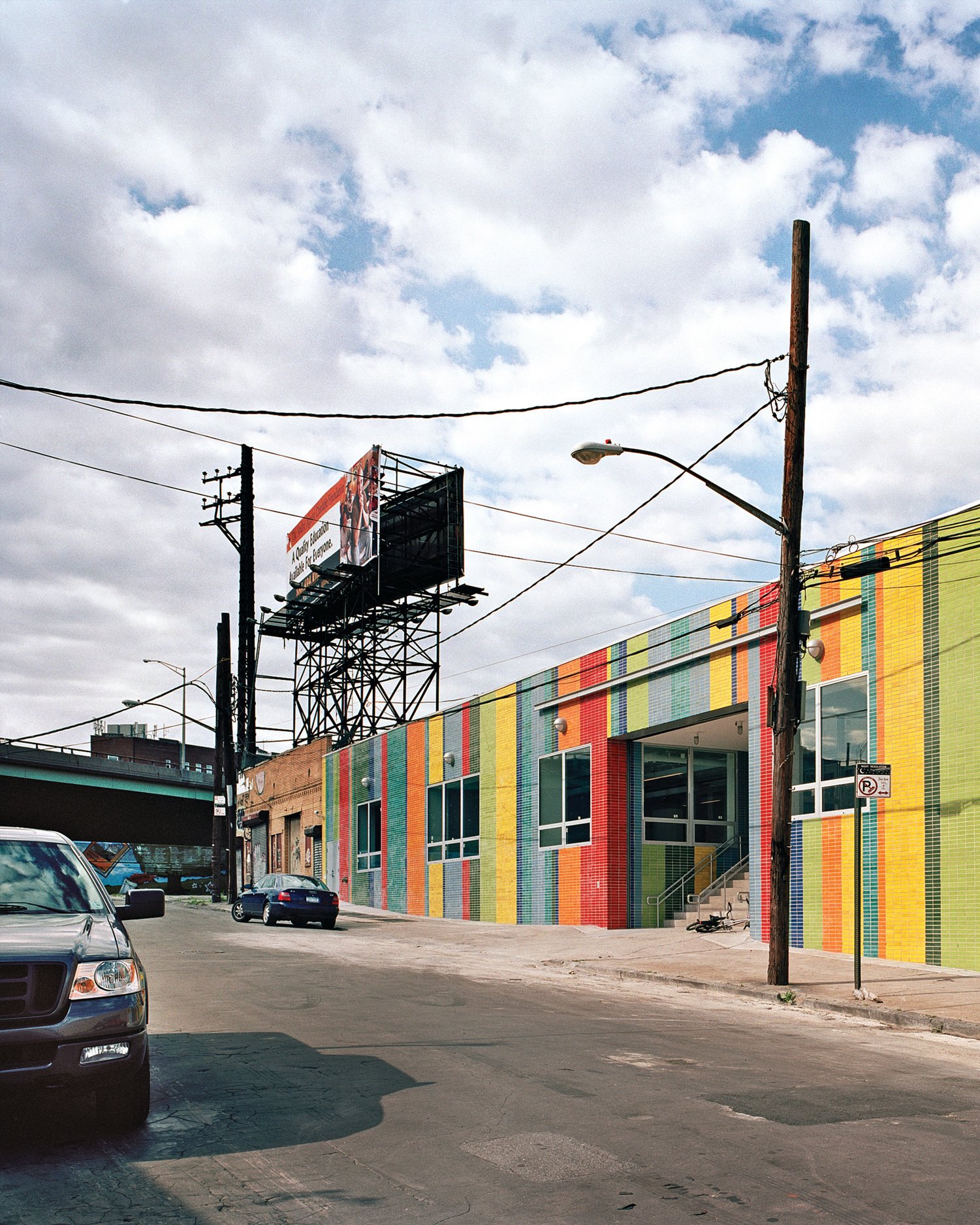 The bright facade of the school after the construction of the industrial building is complete.