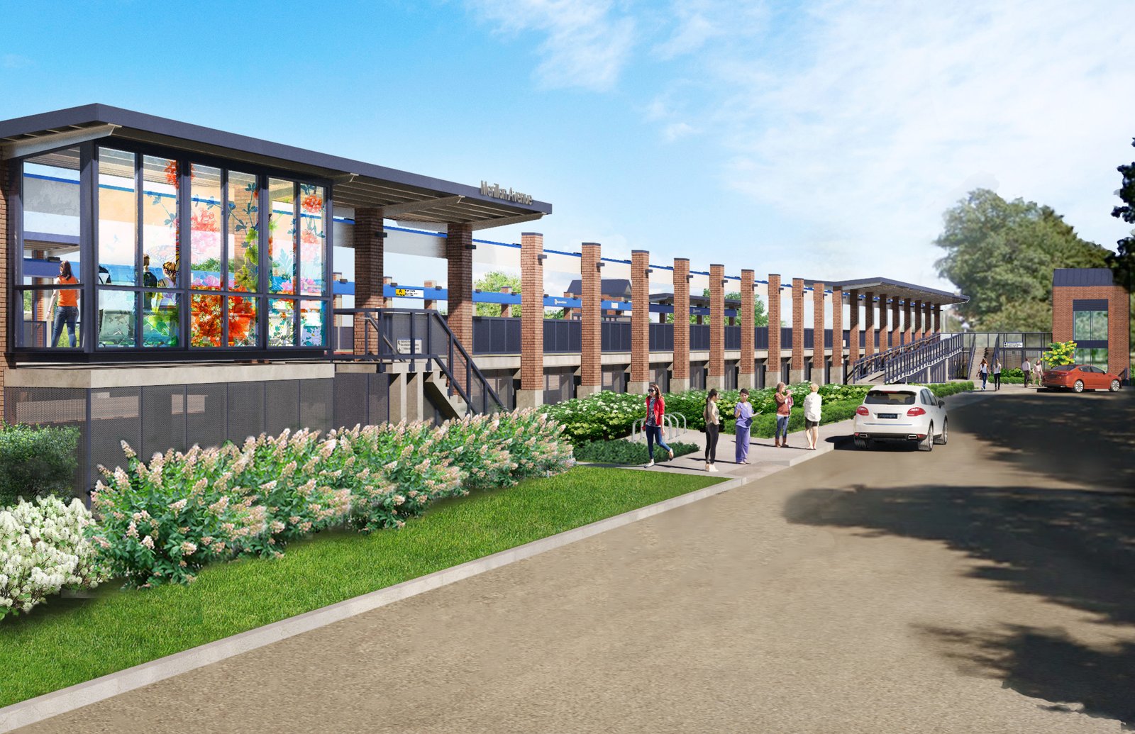 Train station with expansive glass panels and brick columns along the platform.