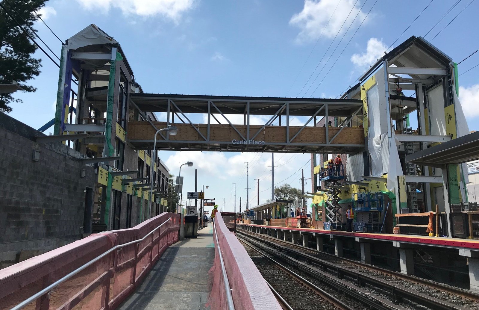 Carle Place station under construction with pedestrian bridge and exposed framework.