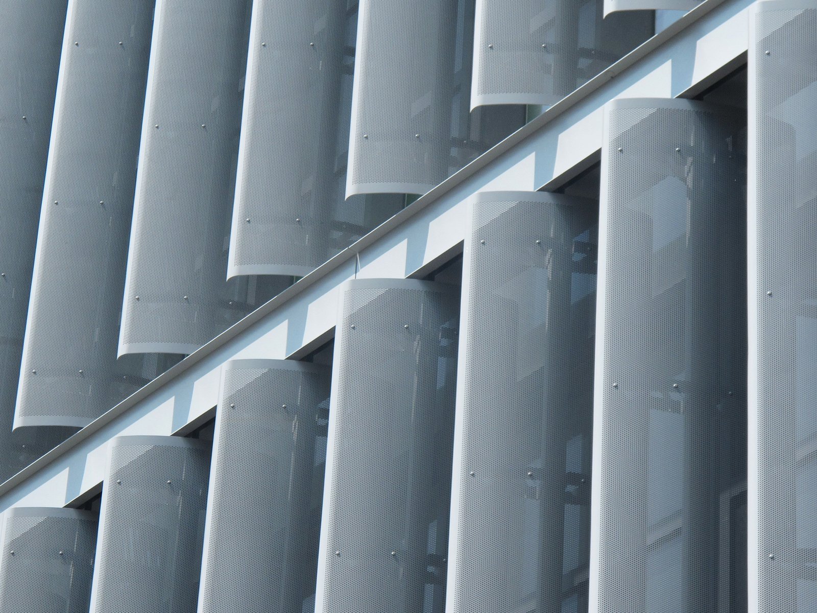 A close-up view of the DSNY garage’s perforated metal fins on the building façade.