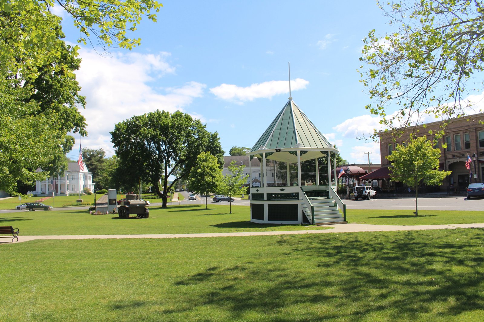 Gazebo in a grassy park in New Milford's town center on a sunny day.