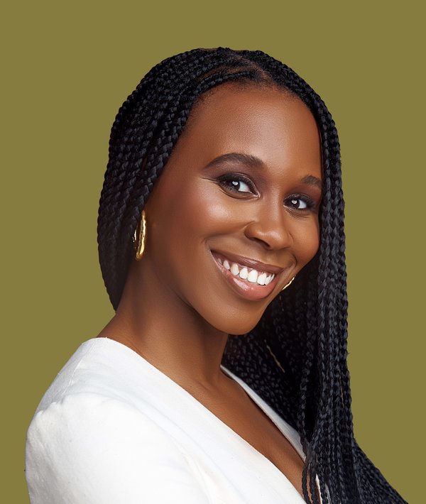 Headshot of Farida Abu-Bakare in a white top against a green background.