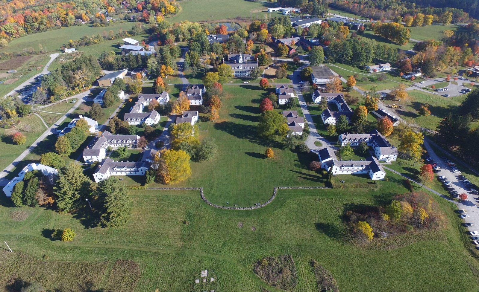 Aerial view of the Bennington College campus with clustered buildings and surrounding green fields.