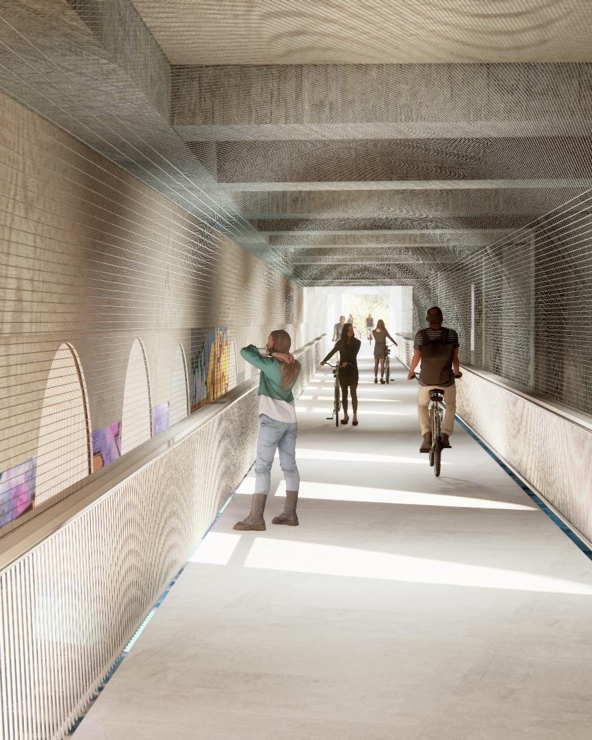 Interior view of a pedestrian and cycling corridor with arched openings and modern mesh detailing.