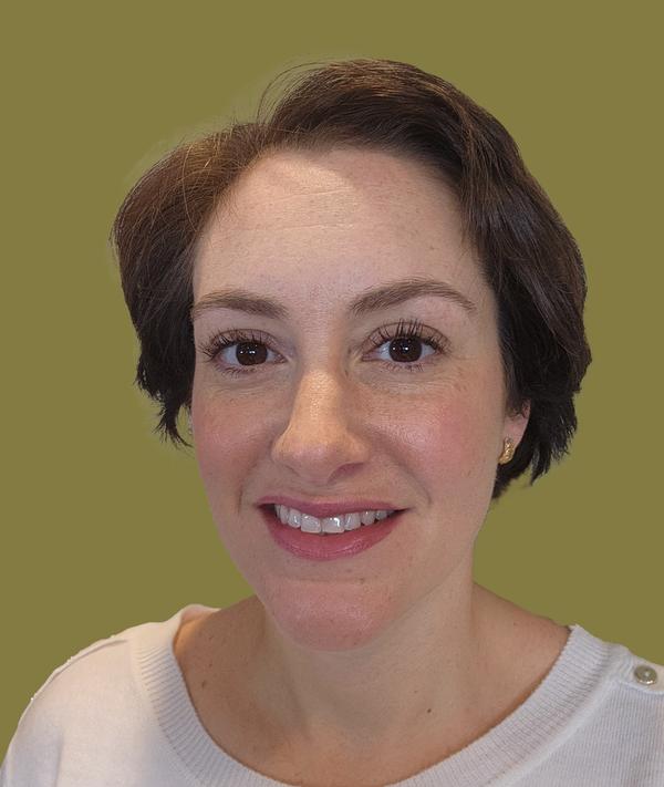 Headshot of Jacqueline McGrath against a green background.