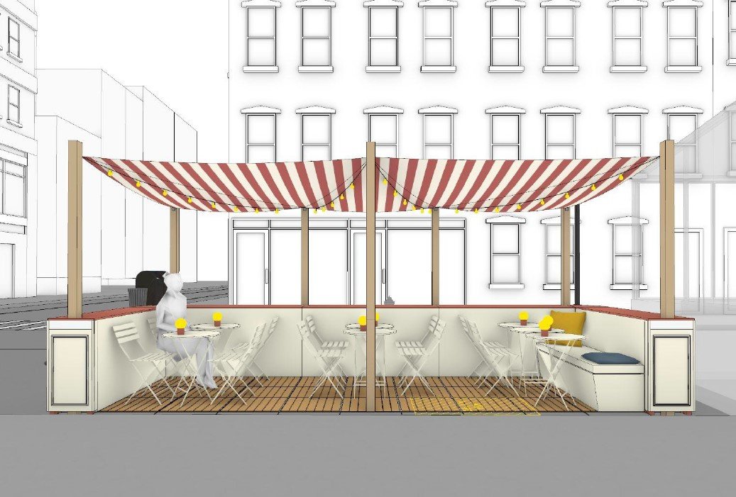 Street-level view of an outdoor dining setup with striped canopy, tables, and chairs.